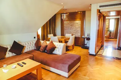 a living room with a couch and a table at Hotel Perce Neige in Ifrane