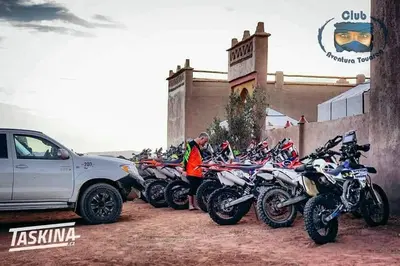 a row of motorcycles parked in front of a building at Porte De Sahara Ouzina in Ouzina