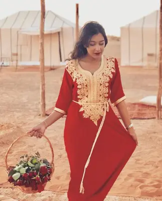 a woman holding a basket of fruits and vegetables at THE SANDY TENTS in Merzouga