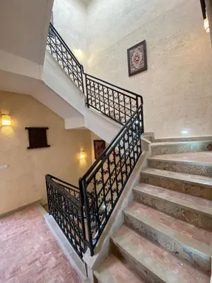 a staircase in a house with a clock on the wall at Riad Zyna in Meknès