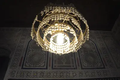 a chandelier hanging from the ceiling of a building at Chez L'habitant Boueden in Fès