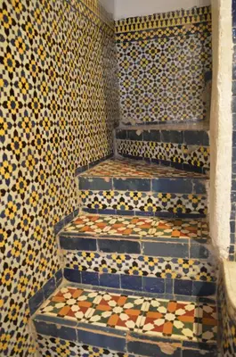 a tiled staircase in a bathroom with tiles on the wall at Chez L'habitant Boueden in Fès