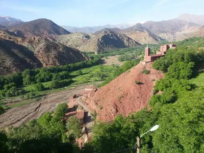 a view of a mountain with a building on a hill at Gte Tawada - Haut-atlas - Chambre pour 3 Personnes in Agouti