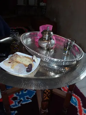 a silver table with a plate of food on it at Gte Tawada - Haut-atlas - Chambre pour 3 Personnes in Agouti
