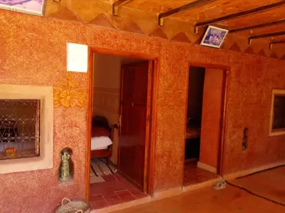a room with a door and a room with a bedroom at Gte Tawada - Valle Heureuse - Chambre pour 3 Personnes in Agouti