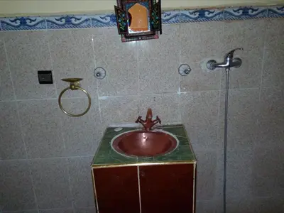 a bathroom with a sink and a shower at Gte Tawada - Haut-atlas - Chambre pour 4 Personnes in Agouti