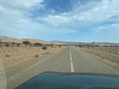 an empty road in the middle of the desert at Atta Desert Camp in El Gouera