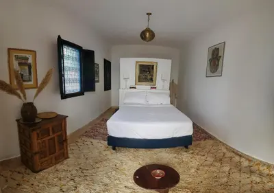 a bedroom with a bed and a table in a room at ourika oufla in Ourika