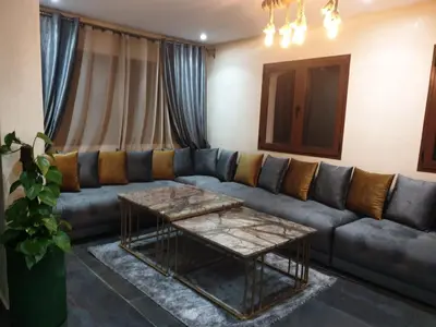a living room with a couch and a table at Chalet Asmoun 2 in Imouzzer Kandar