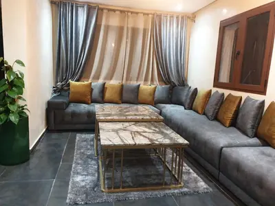 a living room with a couch and a table at Chalet Asmoun 2 in Imouzzer Kandar