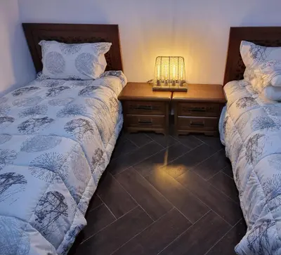 two beds sitting next to each other in a bedroom at Chalet Asmoun 2 in Imouzzer Kandar