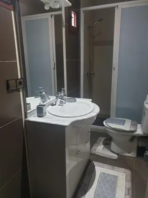 a bathroom with a white sink and a toilet at Chalet Asmoun 2 in Imouzzer Kandar
