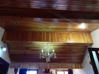 a chandelier hanging from a wooden ceiling at appartement chalet in Imouzzer Kandar