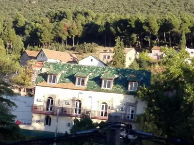 a large white house with a green roof at appartement chalet in Imouzzer Kandar