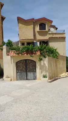 a house with a gate with plants on it at appartement chalet in Imouzzer Kandar