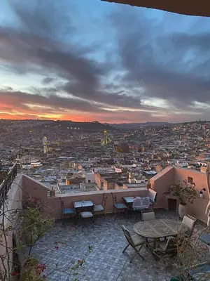 a view of a city from a balcony with tables and chairs at Riad Inaya Fez in Fès