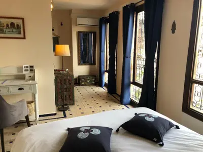 a bedroom with a bed with two pillows on it at Riad Inaya Fez in Fès