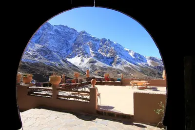 a view of a snowy mountain from a window at Tigmi Tachddirt in Tacheddirt