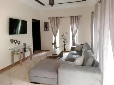 a living room with a couch and a table at Spacious villa with pool near Marrakech in Douar bel Rhanodour