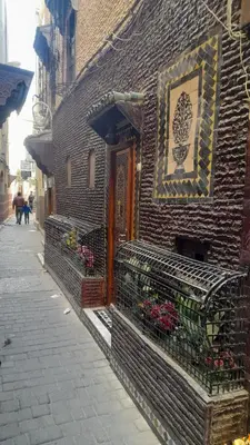 a brick building with flowers on the side of it at Riad amal in Fès
