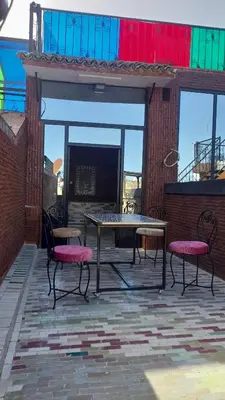 a patio with a table and two chairs on a patio at Riad amal in Fès