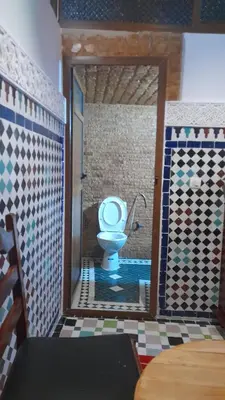 a bathroom with a toilet in a room at Riad amal in Fès