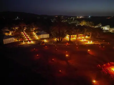 a view of a park at night with lights at Morocco Luxury Desert Camp in Merzouga
