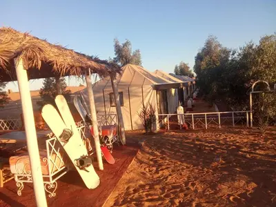 a group of surfboards parked in front of a tent at Tafouyte Luxury Camp in Merzouga