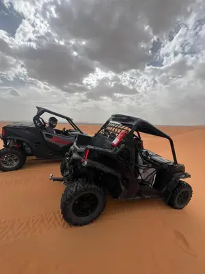 a black atv in the sand in the desert at Tafouyte Luxury Camp in Merzouga