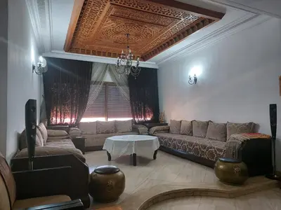 a living room with a couch and a table at Beautiful Apartment Hamria in Meknès