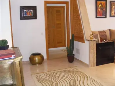 a living room with a door and a cactus at Beautiful Apartment Hamria in Meknès