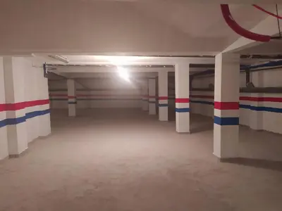 an empty parking garage with red white and blue stripes at Beautiful Apartment Hamria in Meknès