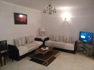 a living room with two couches and a tv at Apartment Centre Meknes in Meknès