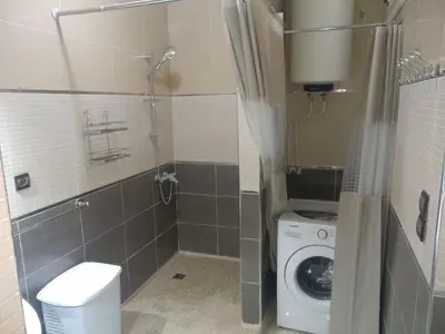 a bathroom with a washing machine and a shower at Apartment Centre Meknes in Meknès