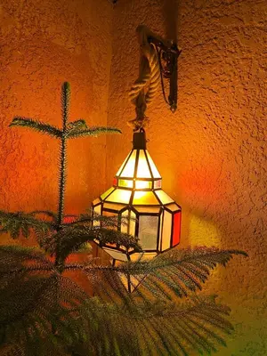 a light hanging on the side of a wall at Hôtel Bia Besta in Boumalne