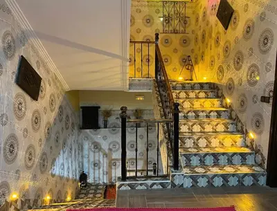 a staircase in a building with yellow walls at Hôtel Bia Besta in Boumalne