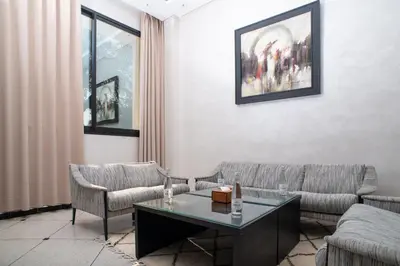 a living room with two couches and a table at HOTEL DES THERMES in Tarmilet