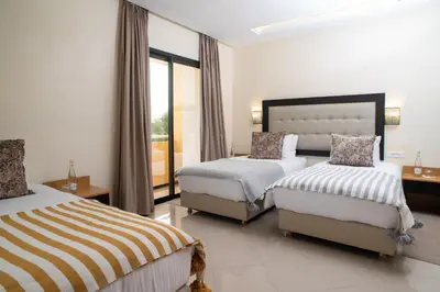 a hotel room with two beds and a window at HOTEL DES THERMES in Tarmilet