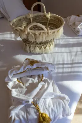 a basket sitting on a table with a towel at Les Iris - Peaceful villa with heated private pool & hammam in Marrakech