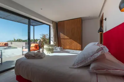 a bedroom with a large bed and a large window at Les Iris - Peaceful villa with heated private pool & hammam in Marrakech