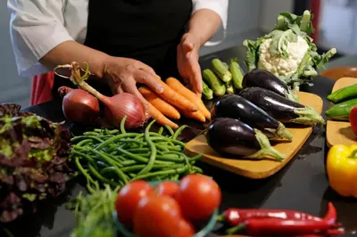 a person is preparing vegetables on a table at Les Iris - Peaceful villa with heated private pool & hammam in Marrakech