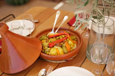 a bowl of vegetables on a wooden table at Les Iris - Peaceful villa with heated private pool & hammam in Marrakech