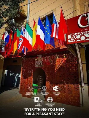 a bunch of different flags hanging from a building at Residence Chay - Luxury Appart in Ouarzazate
