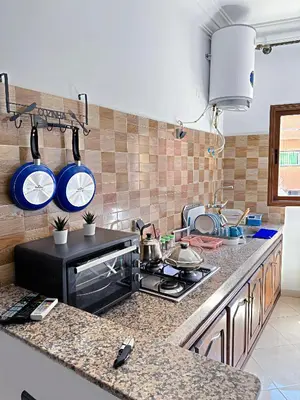 a kitchen with a stove and some pots and pans at Residence Chay - Luxury Appart in Ouarzazate