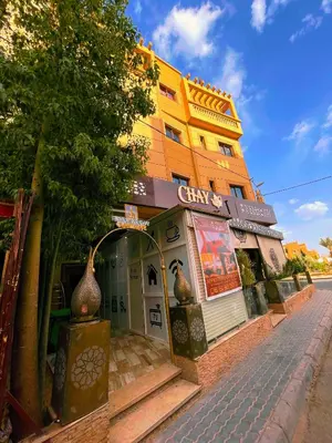 a building with a store on the side of a street at Residence Chay - Luxury Appart in Ouarzazate