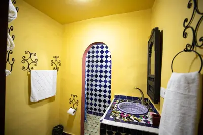 a bathroom with a sink and a mirror at Riad Noha in Fès
