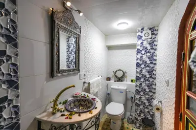 a small bathroom with a toilet and a sink at Riad Noha in Fès