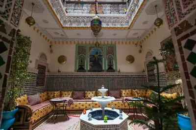 a living room with a couch and a table at Riad Noha in Fès