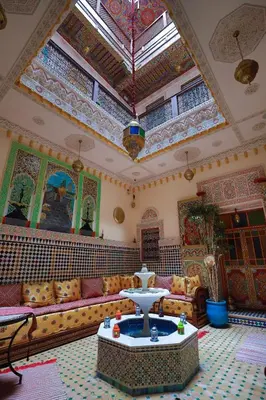 a living room with a couch and a table at Riad Noha in Fès