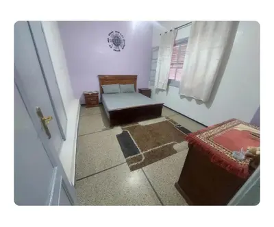 a living room with a couch and a window at Apartment Hamria Meknes BT in Meknès